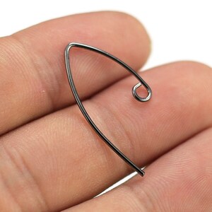 May include: A black metal earring hook with a small loop at the end.