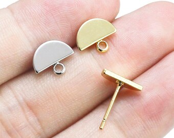 May include: Three gold and silver earring findings. Two are half-circle shapes with a loop at the bottom. The third is a straight bar with a loop at one end.