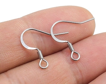 May include: Two silver earring hooks with a spring closure. The hooks are made of metal and are designed to be used with earrings.