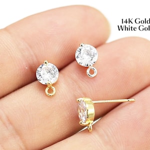 May include: A set of three ceramic mugs with a speckled, matte finish. The mugs are in shades of cream, light gray, and dark gray. Each mug has a simple, minimalist design and a rounded handle. The mugs are likely for coffee or tea.