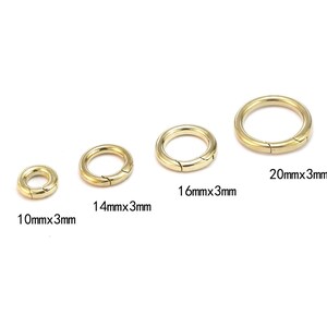 Pode incluir: Quatro fechos de mola redondos dourados de tamanhos variados s&atilde;o exibidos em um fundo branco. Os fechos medem 10 mm x 3 mm, 14 mm x 3 mm, 16 mm x 3 mm e 20 mm x 3 mm. Cada fecho tem uma abertura articulada.