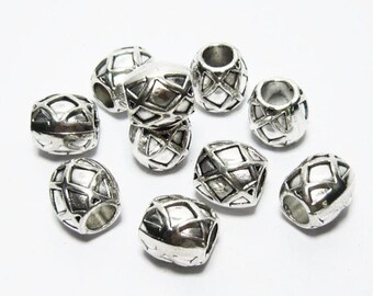 May include: A group of ten silver metal beads with a geometric design. The beads are oval shaped and have a hole in the centre.
