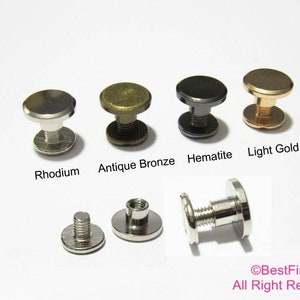 Peut inclure: Assortiment de goujons à visser en métal dans différentes finitions, notamment rhodium, bronze antique, hématite et or clair. Les goujons sont présentés sur un fond blanc.