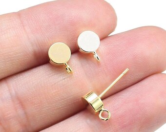 May include: Three gold-toned metal earring findings. Two are round with a loop on the side. One is a straight post with a round top and a loop at the bottom.