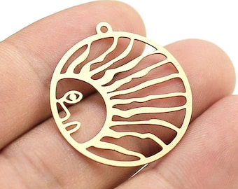 May include: Gold-toned metal charm with a cutout design of a sun with a face. The sun has rays and a stylized face with an eye.