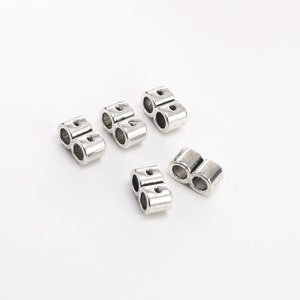 May include: Silver-toned metal clasps for jewelry making. Each clasp has two loops for attaching chains or cords.