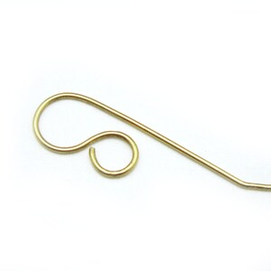 May include: Gold-toned earring finding with a loop and a straight wire.