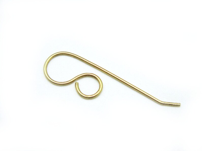 May include: Gold-toned earring finding with a loop and a straight wire.