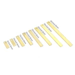 May include: Assortment of gold-coloured metal bar shapes in various sizes, ranging from 9mm to 40mm in length. Each bar is 3mm wide and 0.8mm thick. The bars are arranged in order of size, with the smallest bar on the left and the largest bar on the right.