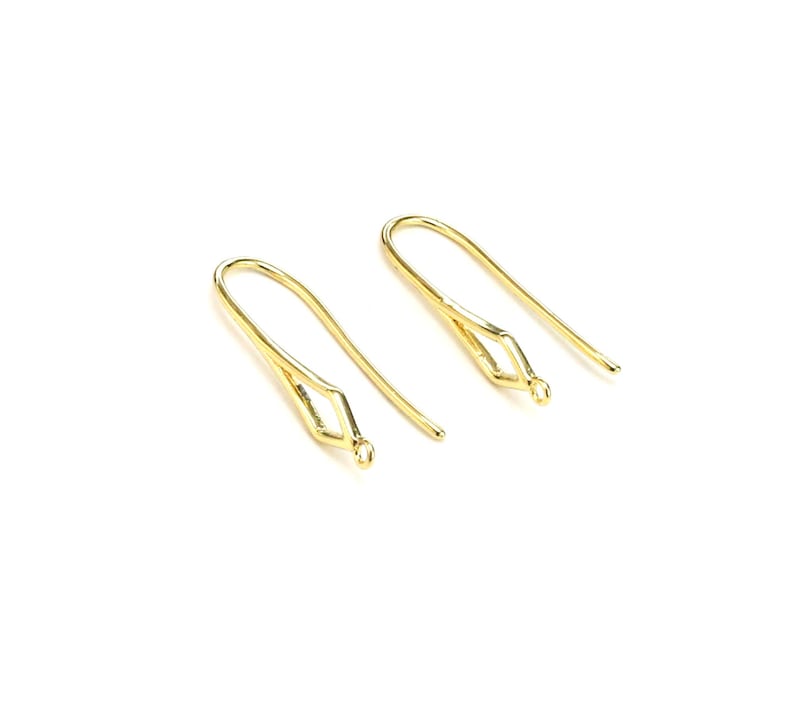 May include: Two gold-toned earring hooks with a diamond-shaped opening at the top. The hooks are made of metal and are designed for attaching earrings.