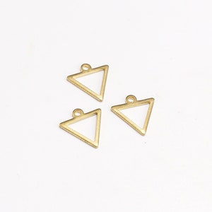 May include: Three gold triangle shaped metal charms with a loop at the top for attaching to jewelry or other crafts.