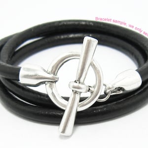 May include: A black leather bracelet with a silver toggle clasp. "Bracelet sample, we only sell clasp" is written on the image.
