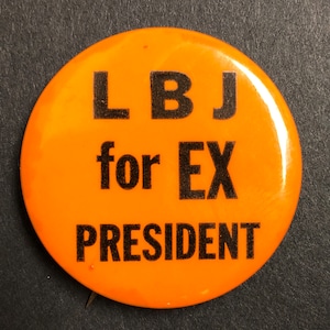 May include: Orange button with black text that reads "LBJ for EX PRESIDENT".