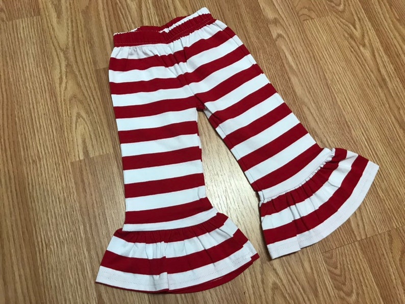 K&ouml;nnte beinhalten: Rote und wei&szlig;e gestreifte Hose mit R&uuml;schen am Saum. Die Hose ist aus einem weichen, dehnbaren Stoff und perfekt f&uuml;r einen l&auml;ssigen Alltagslook.