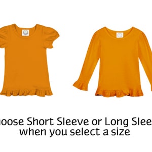 May include: Two orange shirts, one with short sleeves and the other with long sleeves, both featuring a ruffled hem. The text below reads: "Choose Short Sleeve or Long Sleeve when you select a size."