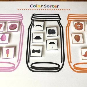 May include: A color sorting activity with three jars. The jars are labeled with a pink, black, and orange border. The jars contain various images of objects in different colors. The images include a pig, donut, cotton candy, bow, popsicle, mustache, hat, bow tie, umbrella, orange, carrot, balloon, pumpkin, and a baseball cap.