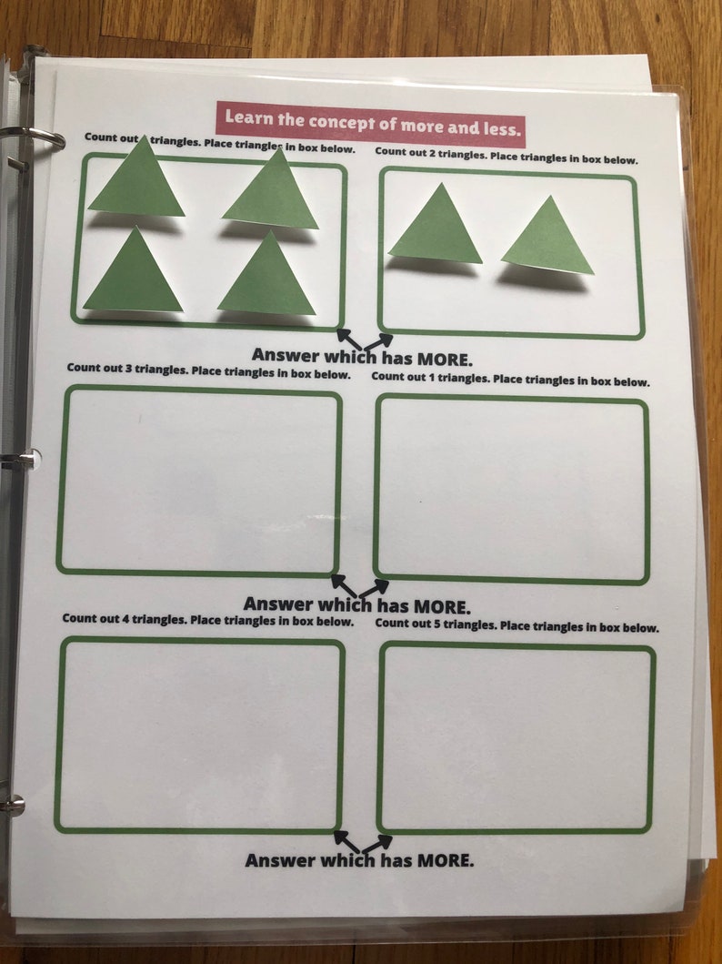 May include: A worksheet with the text "Learn the concept of more and less."  The worksheet has boxes for counting out triangles and placing them in the boxes. The worksheet has instructions to count out 1, 2, 3, 4, and 5 triangles.