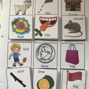 May include: A set of flashcards with pictures and words for learning basic vocabulary. The words include goat, kite, house, mouse, bite, float, kick, dime, lime, bag, stick, and flag.