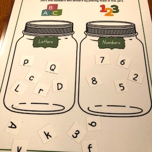 May include: A printable educational activity for children to sort letters and numbers into two jars. The jars are labeled "Letters" and "Numbers". The letters are P, L, C, r, Q, D, A, V, k, 3, and f. The numbers are 7, 8, 6, 5, 2, and 6.