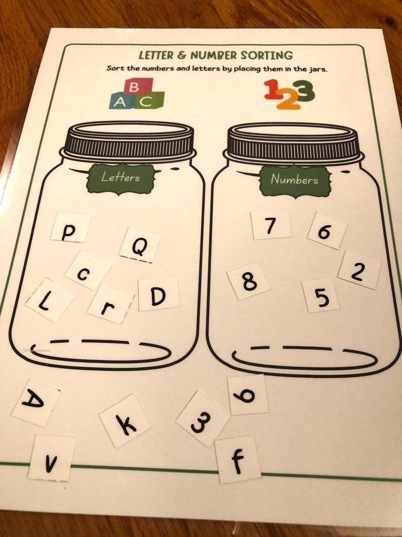 May include: A printable educational activity for children to sort letters and numbers into two jars. The jars are labeled "Letters" and "Numbers". The letters are P, L, C, r, Q, D, A, V, k, 3, and f. The numbers are 7, 8, 6, 5, 2, and 6.