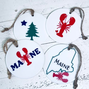 Maine Themed Keepsake Christmas Ceramic Ornaments. Original Maine Flag, Red Lobster, Maine State Outline with Lobster, Maine with lobster