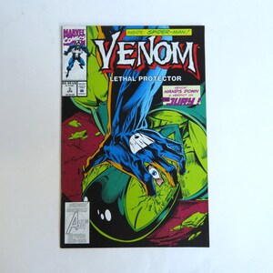 May include: A comic book cover featuring Venom, with the title in bold red letters. The cover art depicts a blue and black hand reaching out, with the text "Lethal Protector" and "Hands Down A Verdict on The Jury!" The Marvel Comics logo is in the upper left corner.