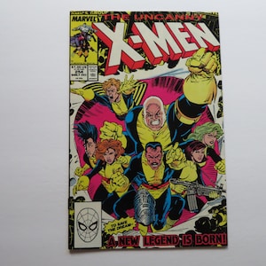 May include: A comic book cover featuring the X-Men. The cover is red, yellow, and blue with a large image of the X-Men characters. The text on the cover reads "The Uncanny X-Men" and "A New Legend Is Born!"