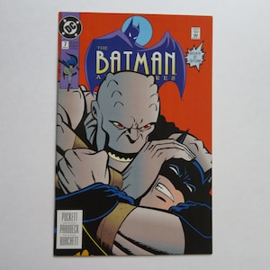 May include: Comic book cover featuring Batman in a fight with a gray, monstrous creature. The cover is red and features the title "The Batman Adventures" with the issue number 7.