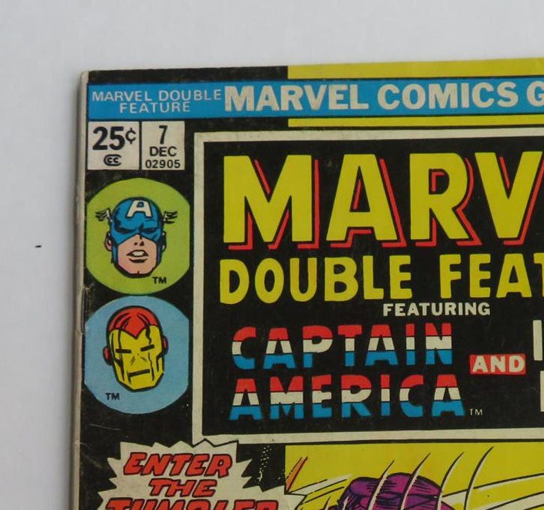 Puede incluir: Una portada de c&oacute;mic vintage con Captain America y Iron Man. La portada es roja, blanca y azul con el t&iacute;tulo "Marvel Double Feature" y "Captain America".