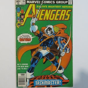 May include: A comic book cover featuring a superhero in a blue and white costume with a skull mask, holding a bow and arrow. The cover is green and orange with the title "Avengers" and the text "Earth's Mightiest Heroes!" The text "Introducing the Treacherous Taskmaster!" is at the bottom of the cover.