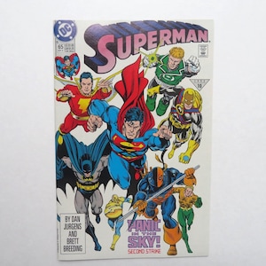 May include: A vintage Superman comic book cover featuring Superman, Batman, and other DC Comics characters. The cover has the title "Superman" in large pink and blue letters. The comic is titled "Panic in the Sky! Second Strike."