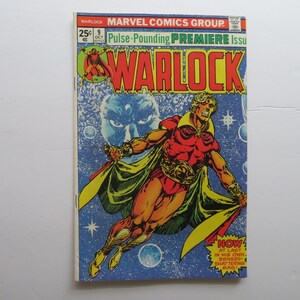 May include: A vintage comic book titled "Warlock" from Marvel Comics Group. The cover features a muscular character in a red and gold costume, with a yellow cape, against a blue space-themed background. The price is 25 cents.