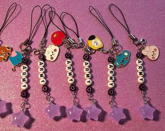 May include: Seven colorful phone charms with purple star beads and black and white beads spelling "ARMY". Each charm features a different cartoon character.