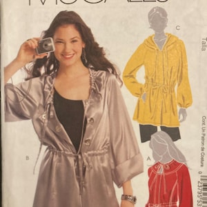 May include: A McCall's M5635 sewing pattern envelope for a jacket with a drawstring waist. The front shows a silver-toned jacket with buttons and a tie, while illustrations depict a yellow hooded version and a red version with a tie-front closure.