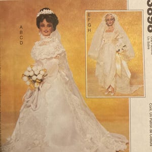 May include: McCall's Crafts sewing pattern envelope 3898 featuring illustrations of two dolls in white wedding dresses with lace details, veils, and bouquets. The text includes McCall's Crafts, 3898, and Pattern/Patron.