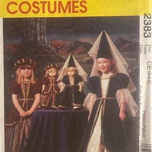 May include: A McCall's Costumes sewing pattern, featuring a medieval princess costume design. The pattern includes sizes for children aged 3-4-5. The image shows a girl and dolls wearing the costume, with a yellow and red logo.