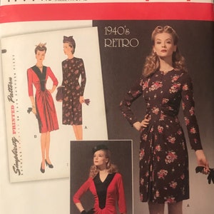 May include: A sewing pattern for a 1940's style dress. The pattern includes three different views of the dress, one in red, one in brown with floral print, and one in black with a floral print. The pattern is for sizes 6-14.