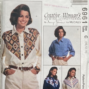 May include: McCall's sewing pattern featuring a woman's shirt with a geometric design on the yoke and cuffs. The pattern includes multiple shirt styles, with sizes 10, 12, and 14. The text "Creative Woman's Sewing Patterns" is visible.