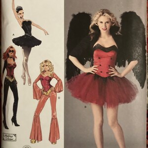 May include: Simplicity sewing pattern number 2067 for a costume with three different looks. The first look is a black tutu and a black corset. The second look is a red corset with a red tulle skirt and black wings. The third look is a red jumpsuit with bell bottoms.