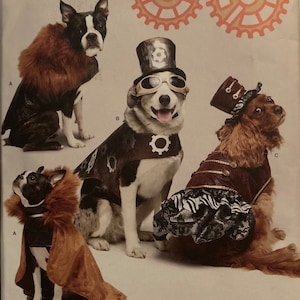 May include: A Simplicity sewing pattern for three dog costumes. The costumes are steampunk themed and feature a brown, black, and white dog wearing a brown cape with fur trim, a black and white dog wearing a brown vest with gears and goggles, and a brown and white dog wearing a burgundy vest with a black and white skirt and a top hat.