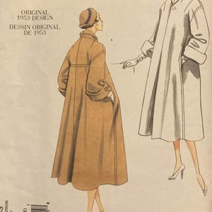 May include: A Vogue Vintage Model sewing pattern envelope featuring an original 1953 design. The illustration displays two variations of a long coat with a collar and cuffed sleeves, shown in tan and white, accompanied by a matching hat and high heels.