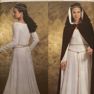 May include: A sewing pattern for a medieval-style gown with a long, flowing skirt and a fitted bodice. The pattern includes a long, flowing cape with a hood. The pattern is for sizes 6-8-10-12. The pattern is from Butterick and has the number B4377.