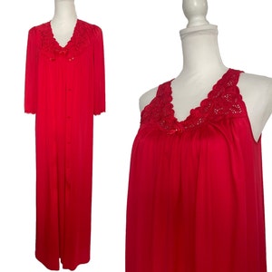 May include: A vibrant red vintage robe and nightgown set. The robe features a V-neck with lace detailing, button closures, and three-quarter sleeves. The matching nightgown has a similar lace design at the neckline. Both items are displayed on mannequins.
