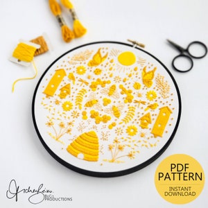 May include: A yellow embroidery pattern featuring a beehive, bees, flowers, houses, and a sun. The pattern is in a hoop and is ready to be stitched. The text "PDF PATTERN INSTANT DOWNLOAD" is in the bottom right corner.