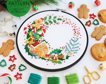 May include: A digital embroidery pattern for a Christmas wreath featuring a gingerbread house, candy canes, holly, and other festive elements. The pattern is available for instant download.