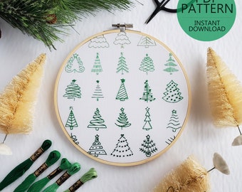 May include: A white embroidery hoop with 20 different green embroidered Christmas tree designs. The hoop is surrounded by green embroidery floss and small brown brushes. The text "PDF PATTERN INSTANT DOWNLOAD" is in a green box at the top of the image.