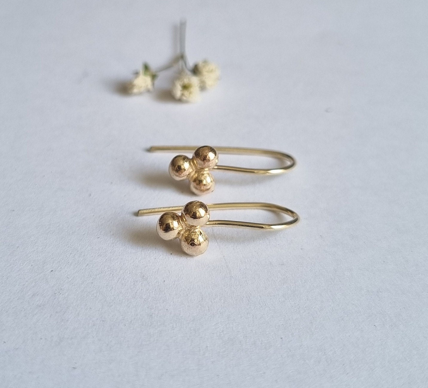 Simple gold earring design on Craiyon