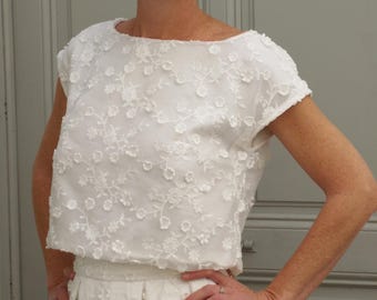 White lace top for a boho-style separate wedding dress. Two-piece wedding outfit with a bridal skirt or trousers.