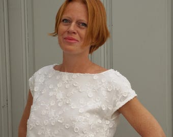 White lace top for a boho-style separate wedding dress. Two-piece wedding outfit with a bridal skirt or trousers.