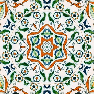May include: A white ceramic tile with a symmetrical pattern of orange, blue and green floral designs. The centre of the tile features a starburst design.